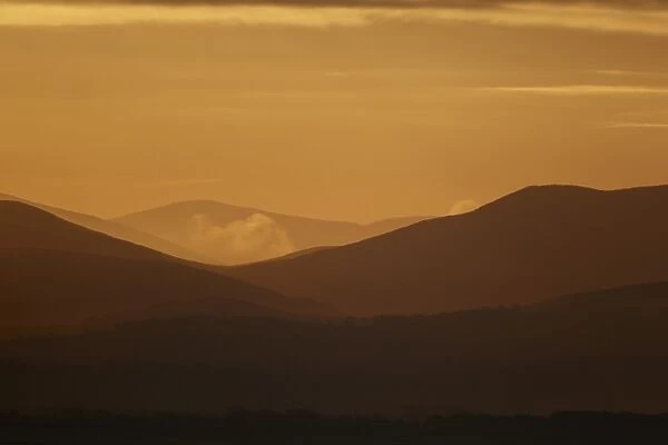 View across estuary towards distant hills at sunrise, looking towards Lake District (Cumbria, England), Solway Firth