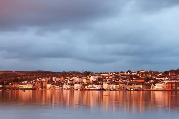 Framed Print : View across estuary at high tide towards town, with rainclouds gathering overhead at sunrise, River Torridge Framed Print : View across estuary at high tide towards town, with rainclouds gathering overhead at sunrise, River Torridge