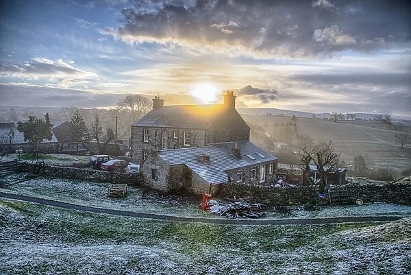 View of farmhouse in frost at sunrise, Church Brough, Kirkby Stephen, Cumbria, England, December
