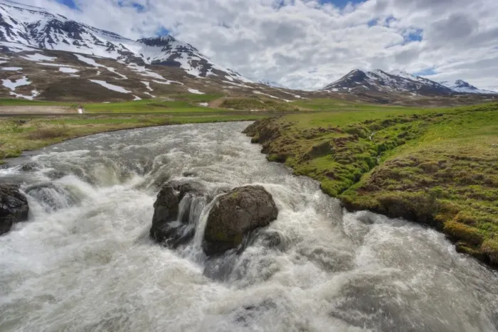Framed Print : View of fast flowing river with mountains in background, Iceland, June Framed Print : View of fast flowing river with mountains in background, Iceland, June