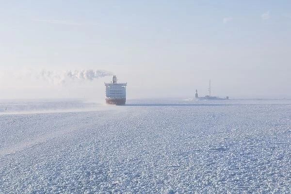 View of ferry in frozen sea at dawn, near Helsinki, Uusimaa, Gulf of Finland, Baltic Sea, Finland, winter