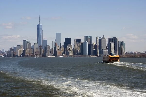 View of ferry on river and city skyline with One World Trade Center skyscraper, Hudson River, Lower Manhattan