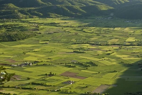 View of field patterns in mountain valley, in evening sunlight, Valle di Frascaro, near Norcia, Apennines, Italy, May