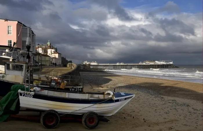 Framed Print : View of fishing boats, beach and pier of seaside town, with stormclouds overhead, Cromer Pier, Cromer, Norfolk Framed Print : View of fishing boats, beach and pier of seaside town, with stormclouds overhead, Cromer Pier, Cromer, Norfolk