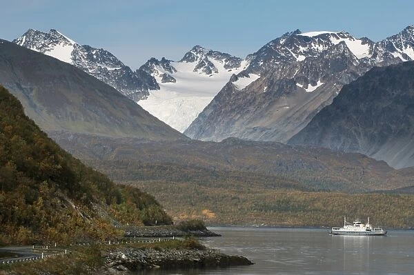 View of fjord and mountains, with boat and highway along shore, Lyngen Fjord, Troms County, Lapland, North Norway