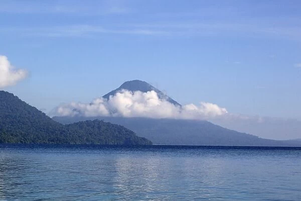 View of forest covered volcano cone on shores of coastal bay, Kimbe Bay, West New Britain Province, New Britain
