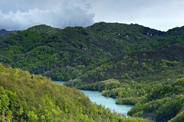 View of forested hills and lake, Lago del Brugneto, Antola Regional Park, Genova Province, Liguria, Italy, may