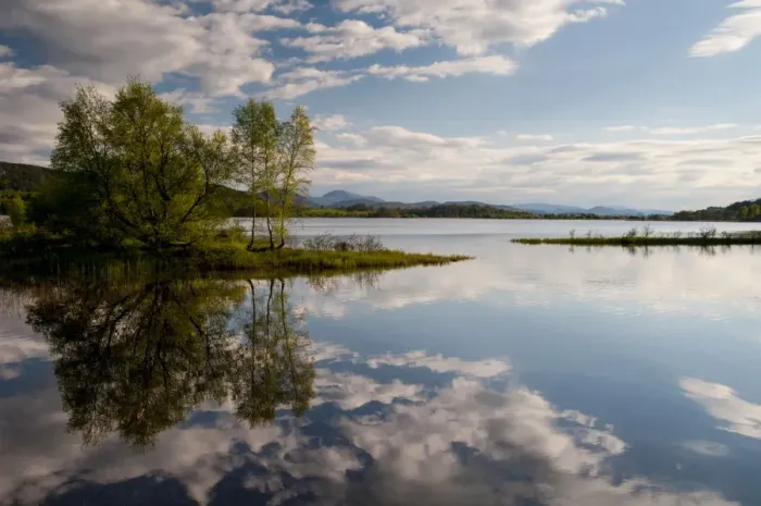 Framed Print : View of freshwater loch with clouds and trees reflected in still water, Loch Insh, Cairngorms N. P