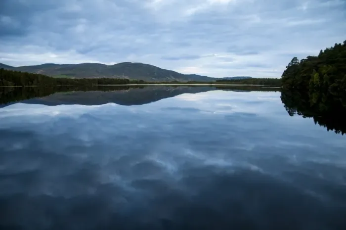 Framed Print : View of freshwater loch with cloudy sky reflected in still water at dusk, Loch Garten, Abernethy Forest N. N. R