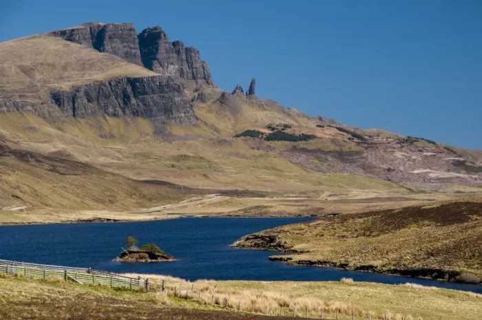 Framed Print : View across freshwater loch towards rocky hill with rock pinnacle, Loch Fada, Old Man of Storr, The Storr Framed Print : View across freshwater loch towards rocky hill with rock pinnacle, Loch Fada, Old Man of Storr, The Storr