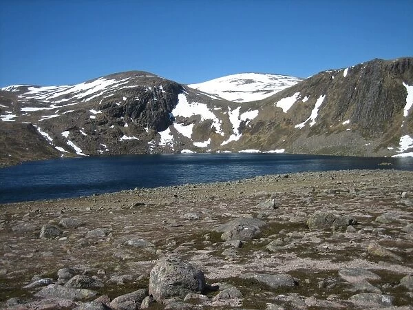 View of freshwater loch and snow covered hills, Loch Etchachan, Central Cairngorms, Cairngorms N. P