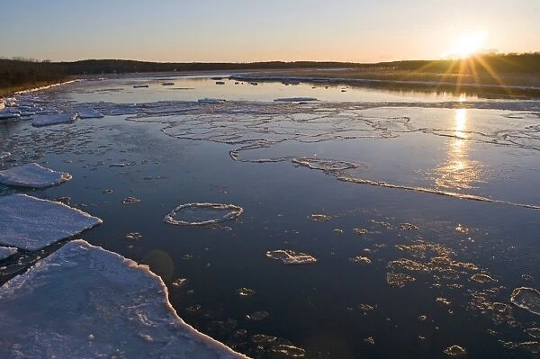 View of frozen river at sunset, Shiretoko Peninsula, Hokkaido, Japan, winter