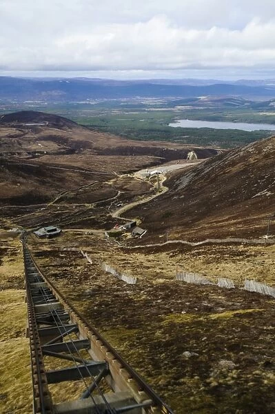 View from funicular railway on snowless mountain, with Aviemore and Loch Morlich in distance, Cairn Gorm