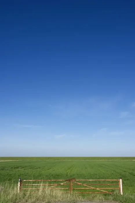 Framed Print : View of metal gate and coastal farmland, Jutland (Jylland), Denmark, may