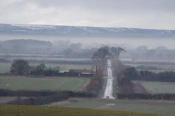 Framed Print : View of mist over fields and rural lane, with low cloud over moorland in distance, North Yorkshire Moors