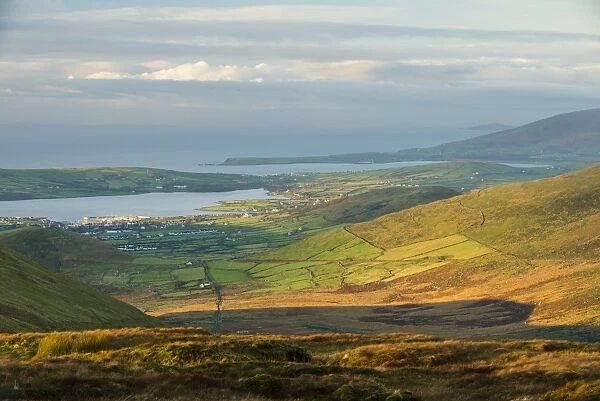 View over moorland towards coastal farmland and village, Dingle Peninsula, County Kerry, Munster, Ireland, November