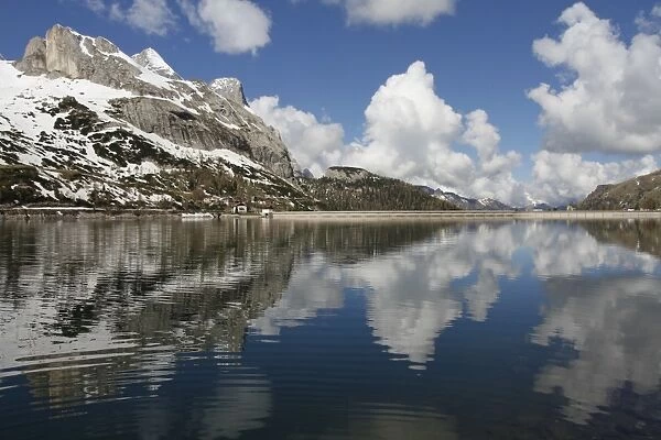 View of mountain peak reflected in hydroelectric artificial lake, Marmolada, Dolomites, Italian Alps, Veneto, Italy