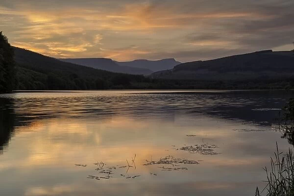 View of reservoir and distant hills at sunset, Penyfan, Taf Fechan Reservoir, Brecon Beacons N. P