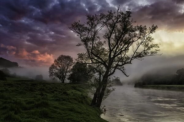 View of river in mist at sunrise, Bigsweir, River Wye, Wye Valley, Monmouthshire, South Wales, May