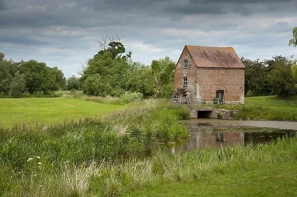 View of river and watermill, Hartpury Mill, River Leadon, Highleadon, Gloucestershire, England, june
