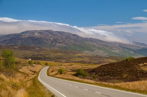 View of road through moorland leading to cloud-topped hill, A Mhoile, Sleat Peninsula, Isle of Skye, Inner Hebrides