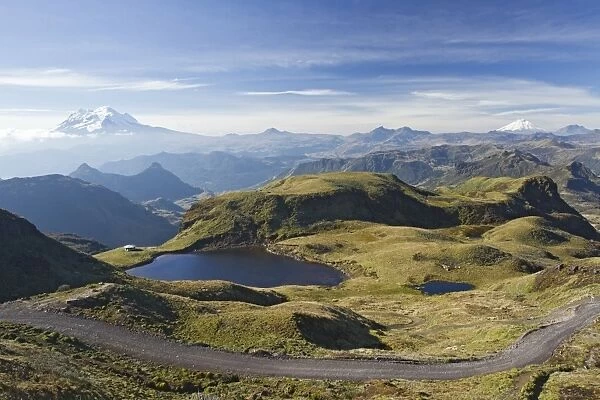 View of road through mountain pass, with snow capped volcanoes in distance, Papallacta Pass, Andes, Ecuador, November