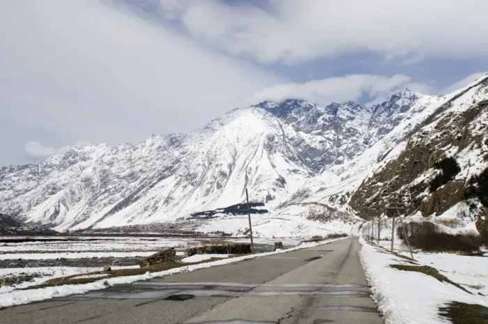 Framed Print : View of road and snow covered mountains, leading to Kazbegi, Great Caucasus, Caucasus Mountains, Georgia, april