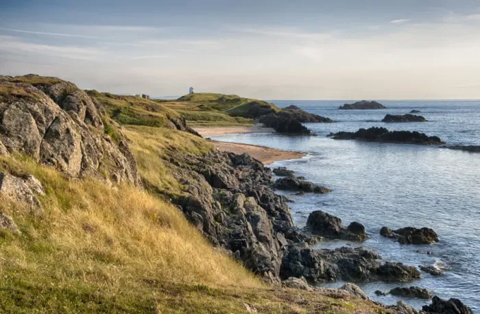 Framed Print : View of rocky coastline and beach on tidal island, Llanddwyn Island, Newborough Warren National Nature Reserve Framed Print : View of rocky coastline and beach on tidal island, Llanddwyn Island, Newborough Warren National Nature Reserve