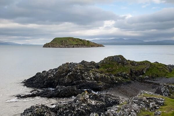 View of rocky coastline and island, Maiden Island, Oban Bay, Inner Hebrides, Argyll, Scotland, May