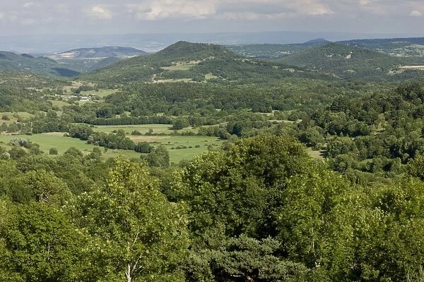 View of rolling wooded volcanic countryside, looking east from Murol, Auvergne, France, August
