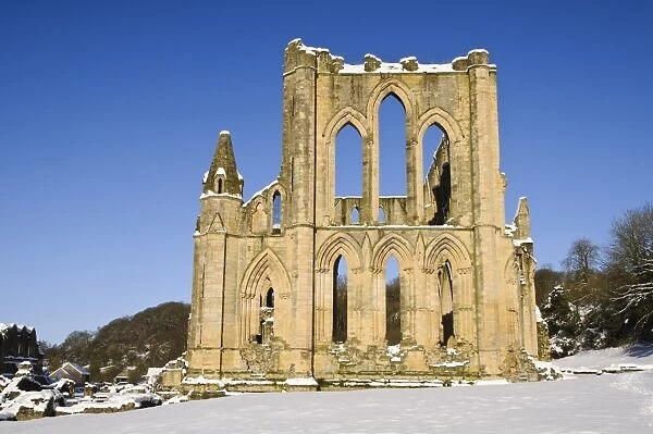 View of ruined cistercian abbey in snow, Rievaulx Abbey, North York Moors N. P. North Yorkshire, England, January