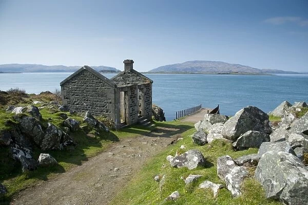 View of ruined ticket office, pier and coastline, Craignish, Argyll and Bute, Scotland, april