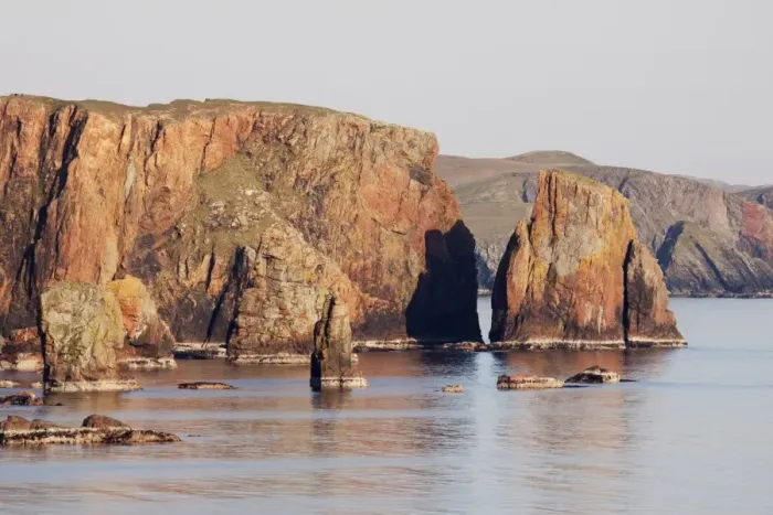 Framed Print : View of sea stacks and cliffs in late afternoon sunlight, Braewick, Mainland, Shetland Islands, Scotland, May
