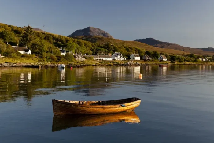 Framed Print : View of small wooden boat and village houses in bay, in morning sunlight, with Beinn Shiantaidh and Corra Bheinn Framed Print : View of small wooden boat and village houses in bay, in morning sunlight, with Beinn Shiantaidh and Corra Bheinn