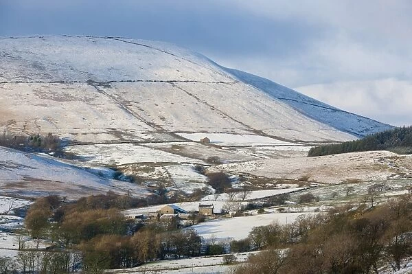 View of snow covered farmland and fell, looking towards Totridge Fell from Long Knots over Higher Fence Wood, Whitewell, Lancashire, England, december