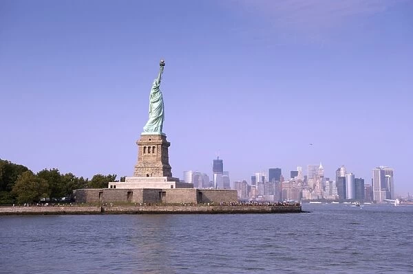 View of Statue of Liberty, with Manhattan Island city skyline in distance, Liberty Island, New York Harbor