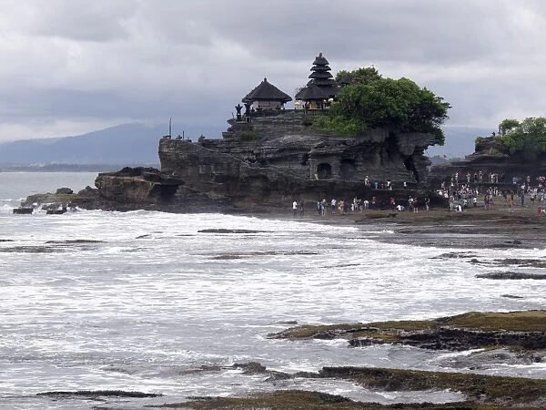 View of tourists at temple on coastal rock formation, Pura Tanah Lot, Tanah Lot, Bali, Lesser Sunda Islands, Indonesia