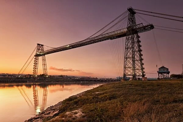 View of transporter bridge over river at twilight, Newport Transporter Bridge, River Usk, Newport, South Wales, Wales