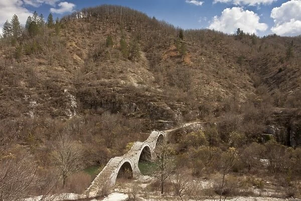 View of triple-arched old packhorse bridge (built 1814), Kalogeriko or Plakida Bridge, Zagoria, Northwest Greece, April