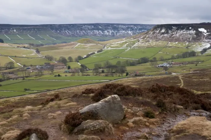 Framed Print : View of upland farmland and moorland habitat with patches of snow along drystone walls, looking from Danby Rigg