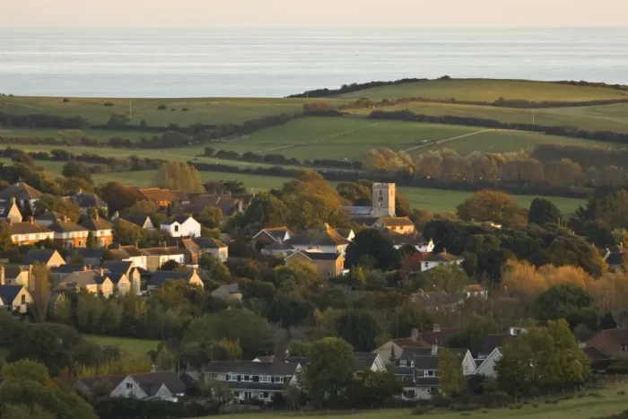 Framed Print : View of village, church, farmland and sea in distance, Preston, Dorset, England, october Framed Print : View of village, church, farmland and sea in distance, Preston, Dorset, England, october