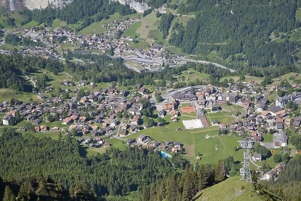 View of village in mountain valley, viewed from Mannlichen, Wengen, Bernese Alps, Switzerland, June