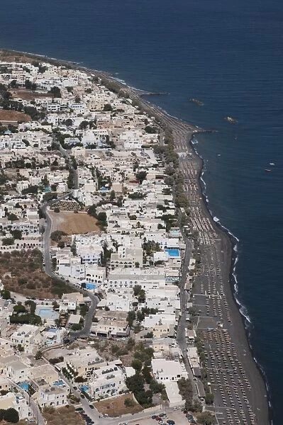 View of village and volcanic beach, Kamari, Santorini, Cyclades, Aegean Sea, Greece, September