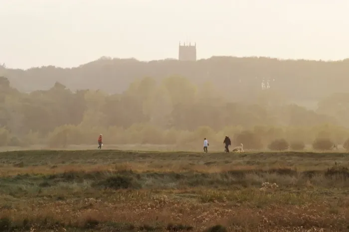 Framed Print : View of walkers with dogs at sunset, with church tower in distance, Cley Marshes, Cley-next-the-sea, North Norfolk Framed Print : View of walkers with dogs at sunset, with church tower in distance, Cley Marshes, Cley-next-the-sea, North Norfolk