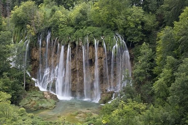 View of waterfall flowing in lake, Plitvice Lakes N. P. Croatia, July