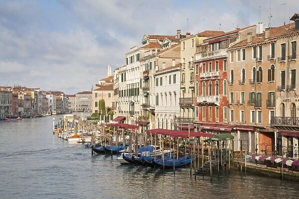 View of waterfront with moored gondolas in early morning, looking from Rialto Bridge, Grand Canal, San Marco District