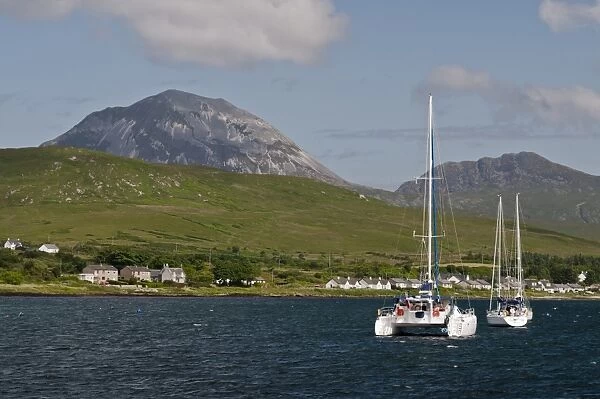 View of yachts moored in bay, with Beinn Shiantaidh and Corra Bheinn, Paps of Jura in background, Craighouse Bay