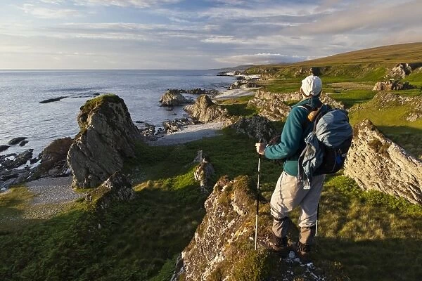 Walker overlooking coastline, looking north along west coast, north from Inver, Isle of Jura, Inner Hebrides, Scotland