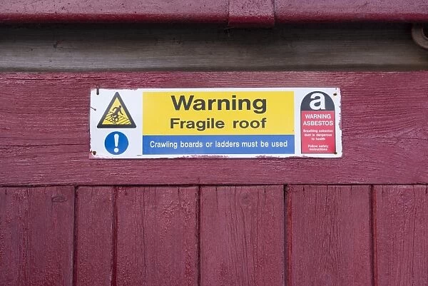 Warning, Fragile roof sign on farm building, Kirkby Stephen, Cumbria, England, March