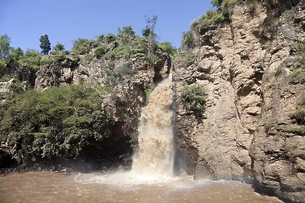 Waterfall flowing into lake, Makalia Falls, Makalia River, Lake Nakuru N. P. Great Rift Valley, Kenya, August